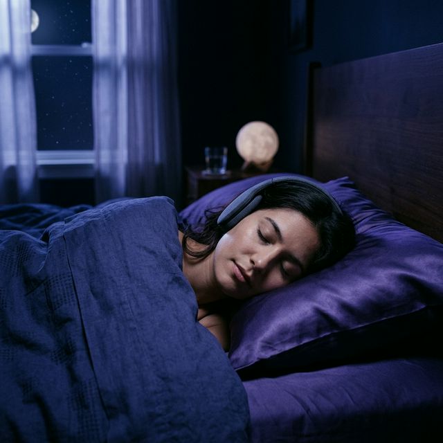 Minimal bedroom at night — soft light, sleep earbuds on pillow, phone with timer set